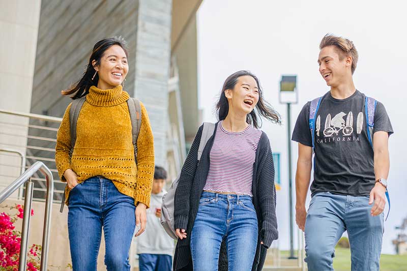 three students walking outside